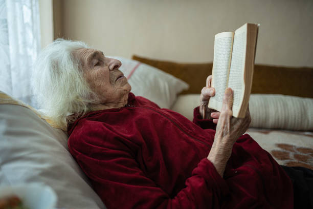 istock Portrait of a 90 years old lady reading book. 1500407199