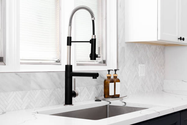 istock A kitchen sink detail with blue and white cabinets and herringbone backsplash. 1500407575