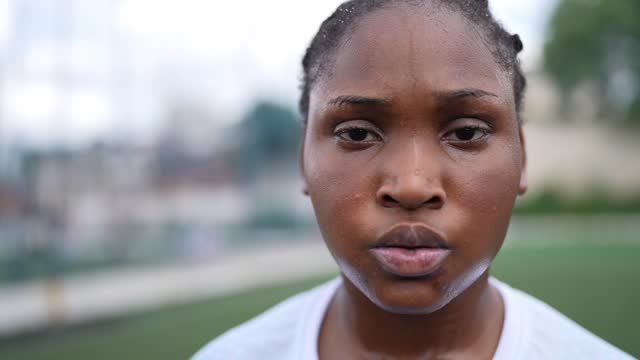 Portrait of a sweaty female soccer player in the soccer field