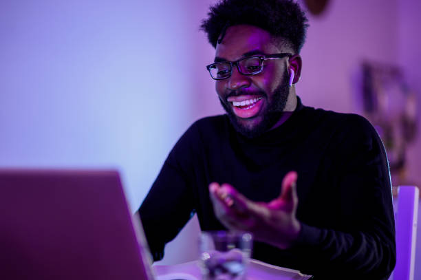 istock A happy interracial freelancer is having a conference call while sitting at home late at night and explaining business tactics. 1500409503
