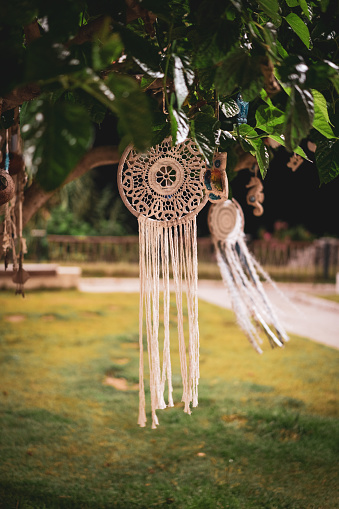 Handmade dreamcatcher hanging in the tree at night