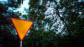 Road sign in the forest, give way