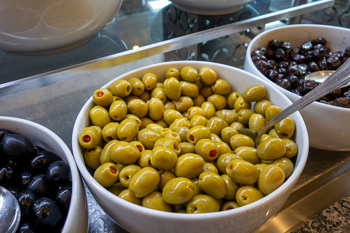 red pepper slice into green olives