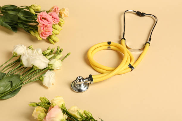 istock Stethoscope and eustoma flowers on beige background. Happy Doctor's Day 1500413778