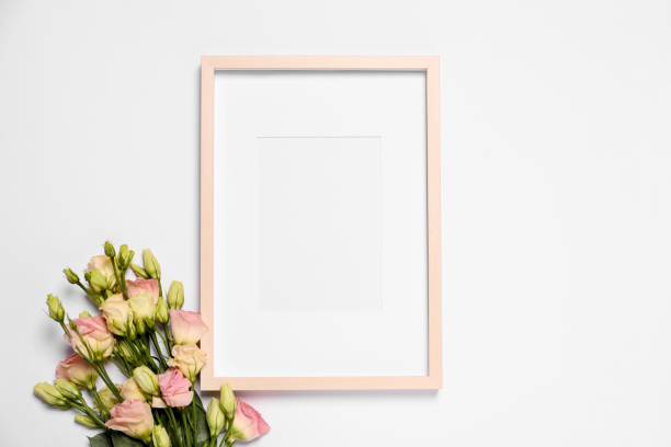 istock Empty photo frame and beautiful flowers on white background, top view. Space for design 1500413844