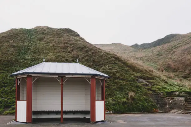 A Victorian seaside shelter at Saltburn-by-the-Sea on a misty day.