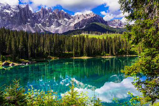Idyllic nature scenery- turquoise mountain lake Carezza surrounded by Dolomites rocks- one of the most beautiful lakes of Alps. South Tyrol region. Italy