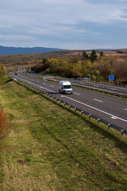 istock White delivery van on the highway. White modern delivery small shipment cargo courier van moving fast on motorway road to city urban suburb. The world's best transport of goods. 1500415795