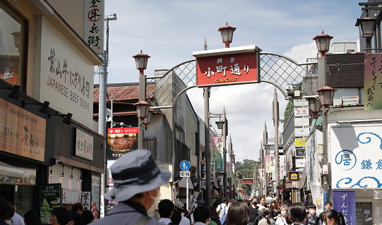 May 25, 2023 - Kamakura, Japan: Crowds of shoppers and visitors walk Komachi Street on a spring afternoon.