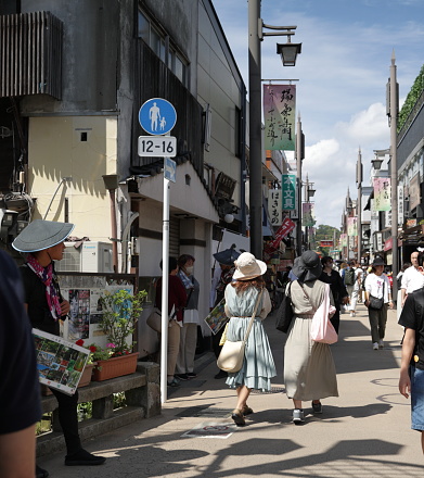 May 25, 2023 - Kamakura, Japan: Hundreds of shoppers and vendors line Komachi-dori near Kamakura Station on a spring afternoon.