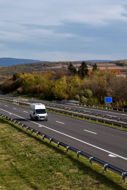istock White delivery van on the highway. White modern delivery small shipment cargo courier van moving fast on motorway road to city urban suburb. The world's best transport of goods. 1500417096