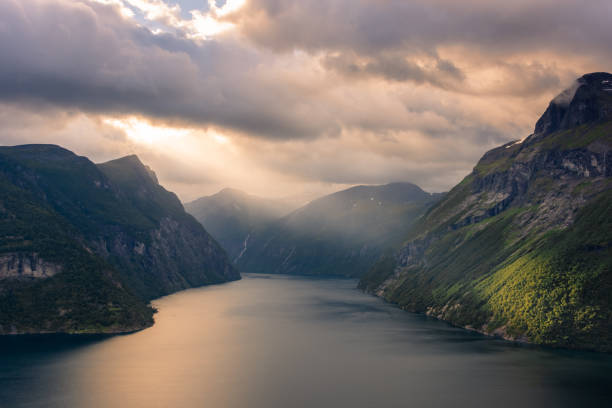 istock Dramatic sunbeam from the clouds over the Geirangerfjord,  Norway 1500418970