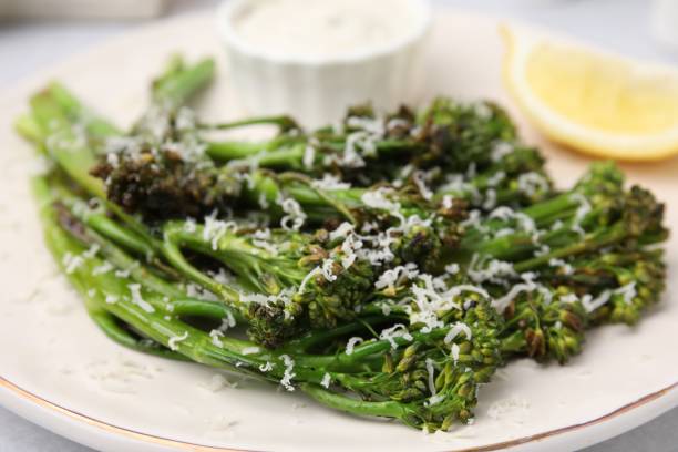 istock Tasty cooked broccolini with cheese on plate, closeup 1500419581