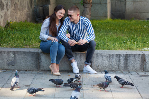 istock Young couple feeding pigeons 1500420220