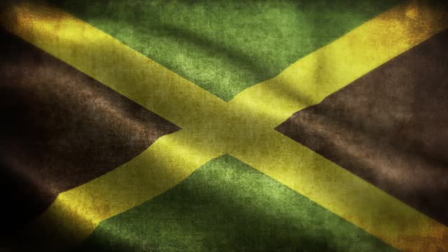 Closeup of grunge Jamaica waving flag loopable stock video