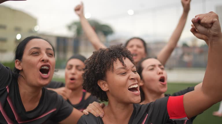 Female soccer players celebrating a goal during a match