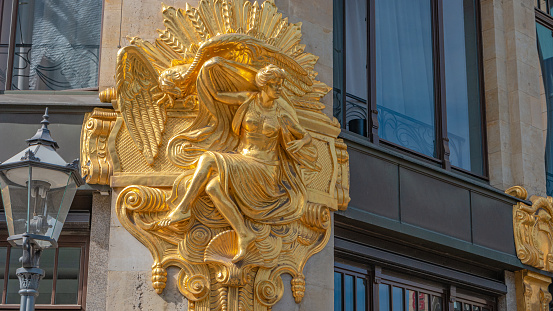 Leipzig, Germany, August 7, 2022: Golden decoration at the building in the historical downtown and shopping center of Leipzig