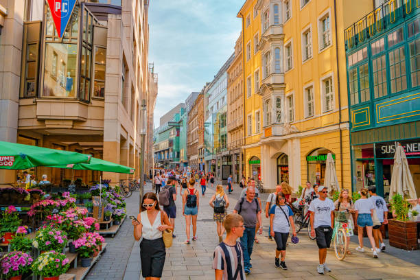 Leipzig, Germany - August 2, 2022: Summer outdoor cafes and restaurants. Cityscape of historical downtown and shopping center in Leipzig at summer hot sunny day.