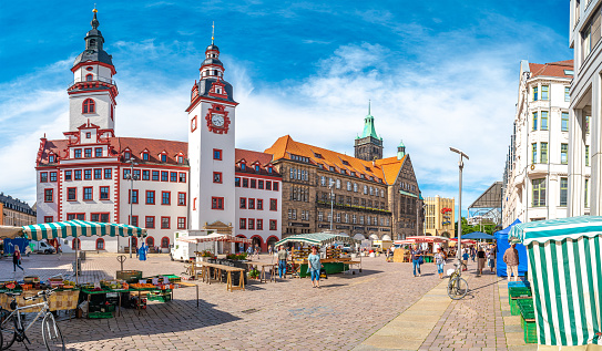Chemnitz, Saxony, Germany, June 21, 2022: Panoramic view of the Old Town Hall in the historic downtown of Chemnitz, with street food market at blue sky and sunny summer day