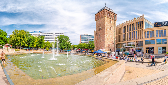 Fountains, old water tower, shopping centers and people in the historic downtown of Chemnitz, Germany