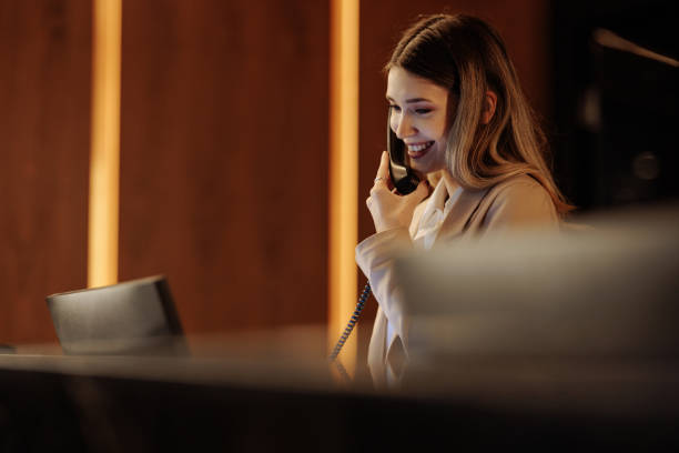 istock Young Caucasian hotel receptionist talking on phone 1500431074