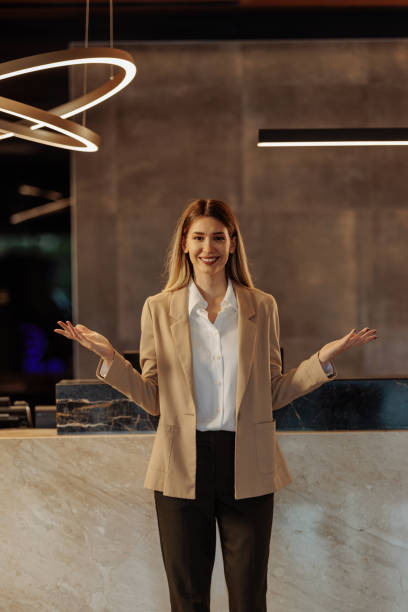 istock Young hotel receptionist standing in front of counter 1500431909
