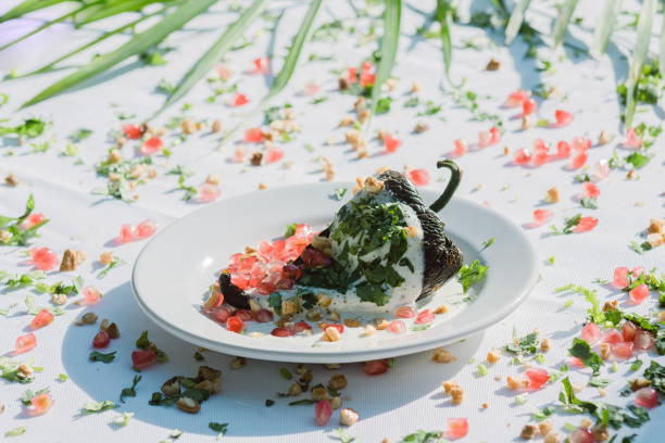 istock Chiles en Nogada: A traditional Mexican dish featuring stuffed peppers with walnut sauce and fruit garnish. 1500434538