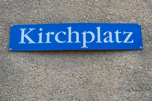 View over an old wall street name plate saying in German Church Square in Germany