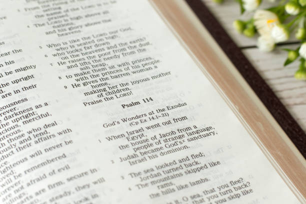 istock Psalm 114, open holy bible book on wooden table, close-up 1500436467