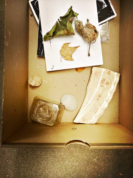 istock Box with a broken plate, inkwell, leaves and postcards in a box on a Stoop 1500440058