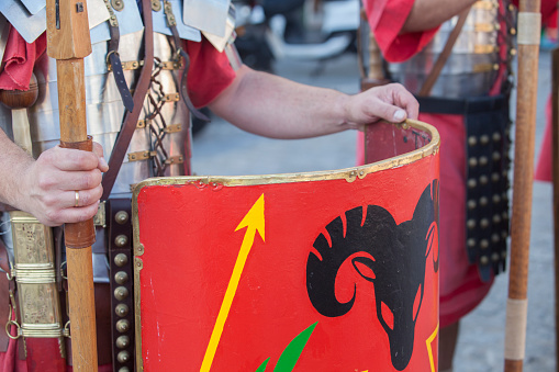 Reenactors as roman legionaries in formation. Hands holding pila and javelins