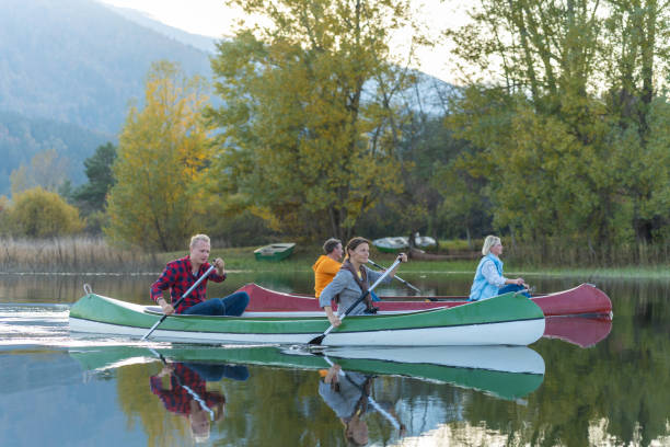 Travelers in canoes on Lake Cerkniško Excursionists enjoy and have fun exploring Cerknica Lake in good weather and at sunset. cerknica lake stock pictures, royalty-free photos & images