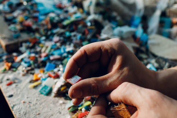 istock Man mosaics master chooses select smalt glass pieces for mosaic panel. Male mosaicist at work. 1500449960