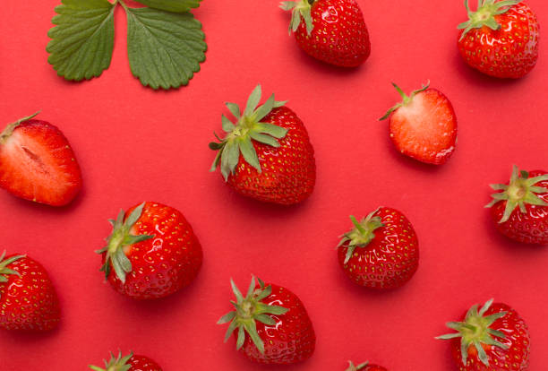 istock Strawberries with leaves on color background, top view 1500457270