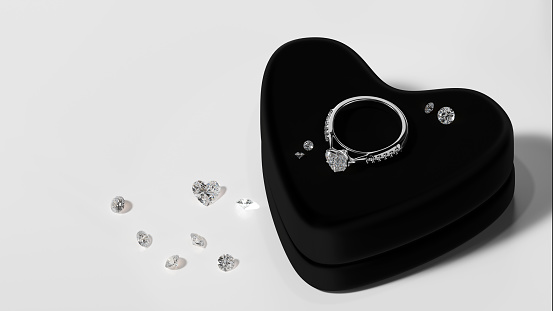 3D render design white gold diamond ring is placed on a black velvet jewelry box with various sizes of diamonds on the floor. The concept of a studio in a jewelry store.