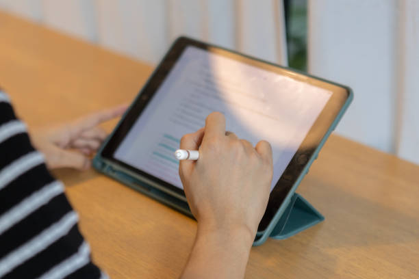 istock Female using digital tablet. woman working key touch display pad tablet. 1500462956