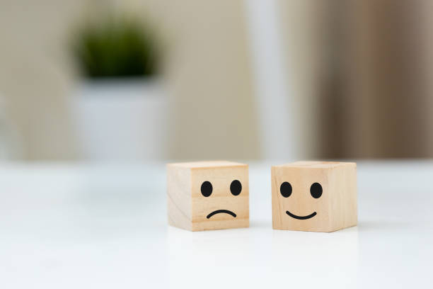 istock Wooden block with happy and unhappy face. 1500462957