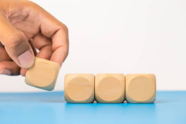 istock Concept of education and development. Hand picking blank wooden cube block sort on table use for create text or symbol. growth success. 1500464258