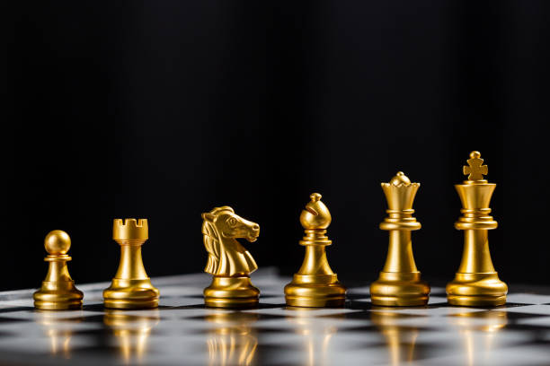 istock Chess game gold team standing on board. strategic business leadership successful teamwork. business leader concept. strategy challenge business of successful. 1500464318