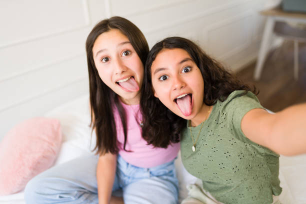 istock Funny teenagers taking fun selfies while hanging out 1500468771