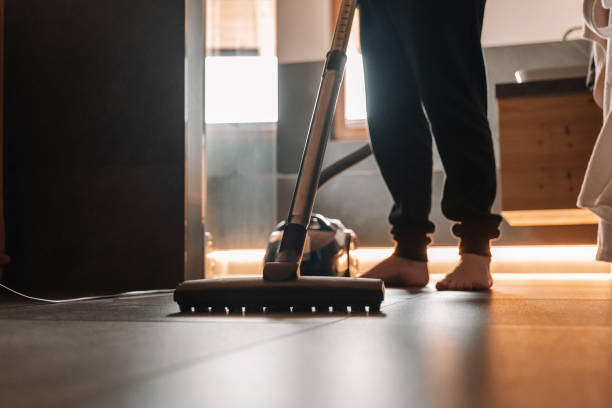 istock man is vacuuming in a bathroom.Vacuum cleaner 1500472707