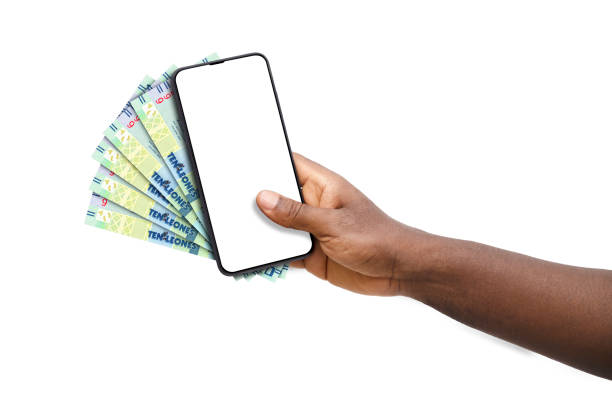istock Black hand holding mobile phone with blank screen and Sierra Leonean Leone notes 1500472956