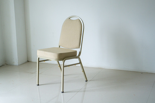 Empty chair at the room corner. comfotable chair in empty white room. loneliness concept