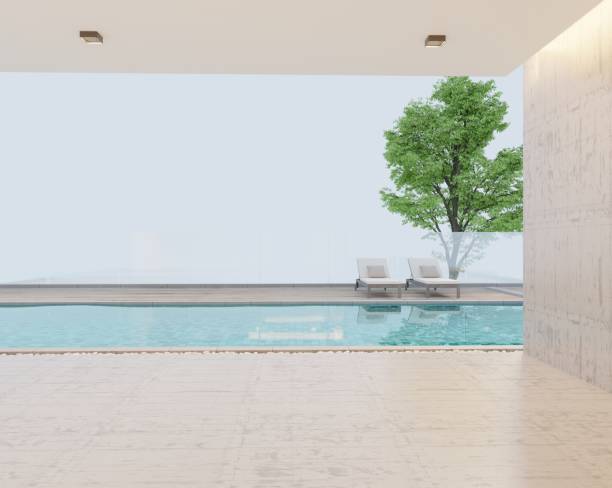 istock A simple modern empty basement terrace with polished cement tile floors and polished cement walls overlooking mature trees and swimming pool. decorated with 3D sun loungers 1500481283