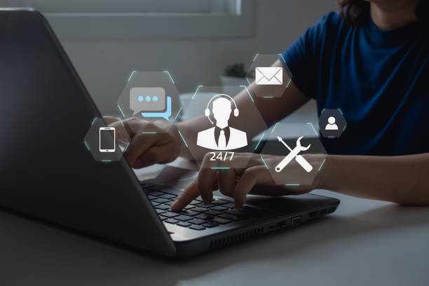 istock Technical Support Center Customer Service Internet Business Technology Concept. online technical support, and customer service 24/7 nonstop. Business people using laptop with helpdesk icon on screen. 1500481289