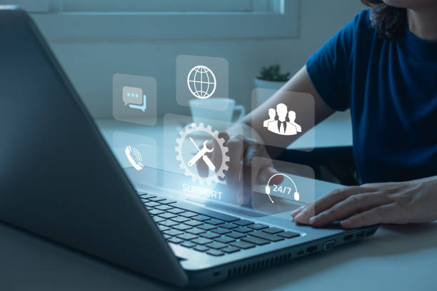 istock Technical Support Center Customer Service Internet Business Technology Concept. online technical support, and customer service 24/7 nonstop. Business people using laptop with helpdesk icon on screen. 1500481310