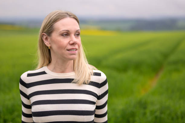 istock Woman standing in front of a green field 1500481908