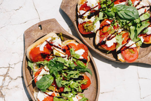 panino caprese fresco su un tavolo - caprese salad foto e immagini stock