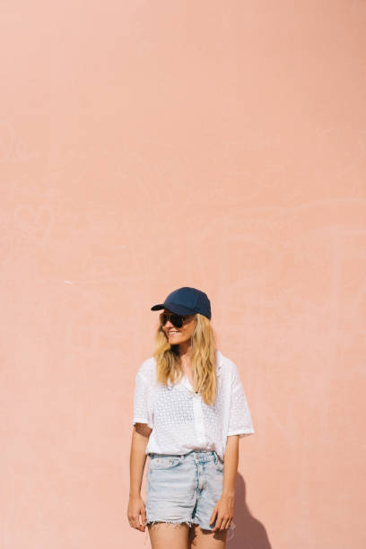 istock Young woman in front of pink wall 1500483494