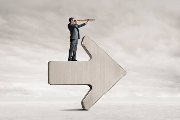 istock Man Looking Through Spyglass Stands On An Arrow 1500484500